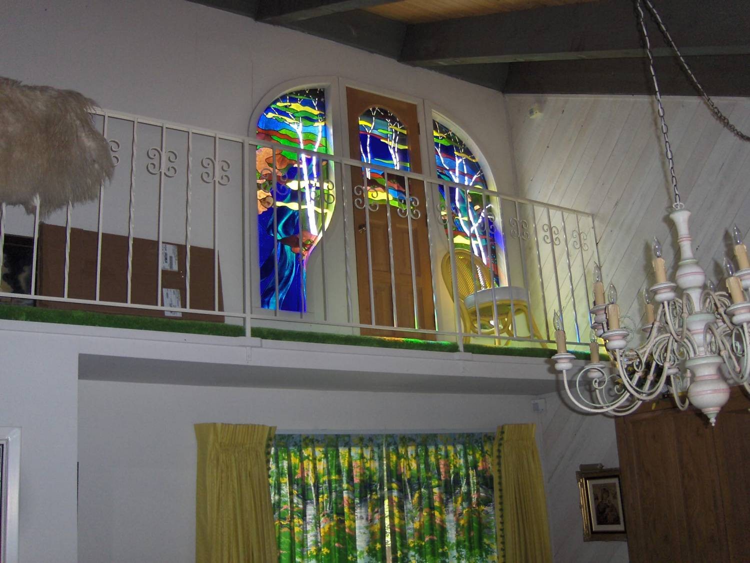 Stained glass windows above master bedroom